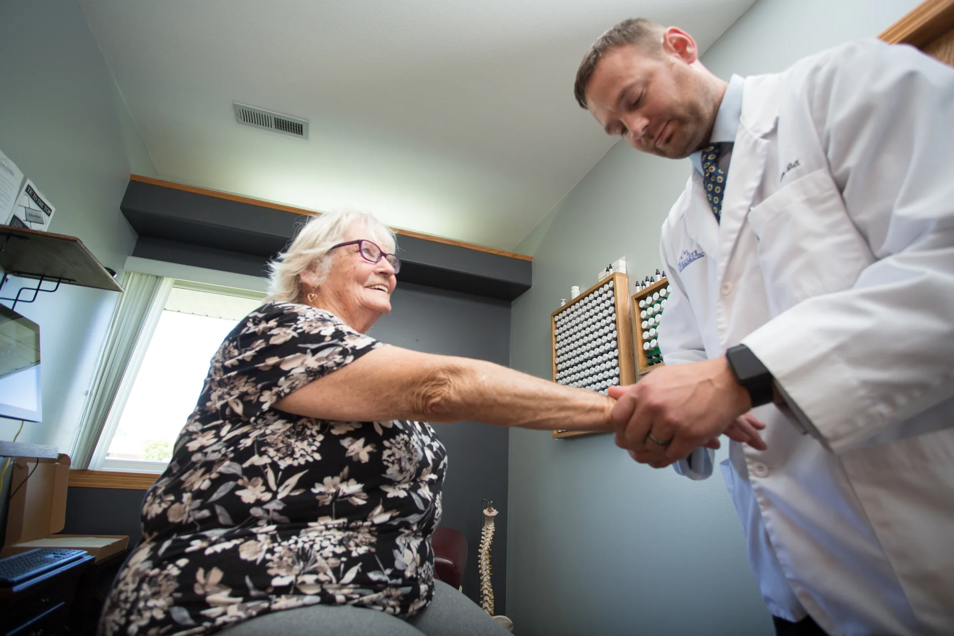 A clinician examining a patient’s wrist