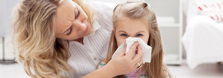 Chiropractic Wichita KS Wellness Support Woman With Toddler Blowing Nose