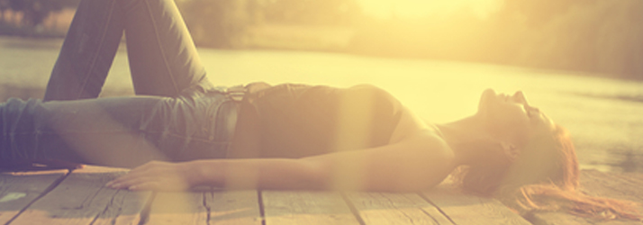 Chiropractic Wichita KS Wellness Sun Woman Lying On Wooden Decck In The Sun